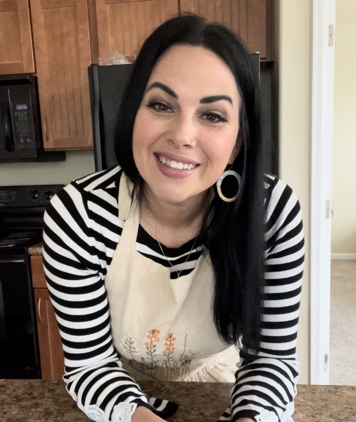 Woman wearing an apron in a cozy homestead kitchen preparing food from scratch